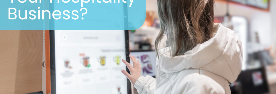 Self-service ordering kiosk in a restaurant with customer using touchscreen to place food order connected to EPOS system.